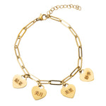 A gold-colored bracelet featuring multiple heart-shaped charms with Japanese characters engraved on them.